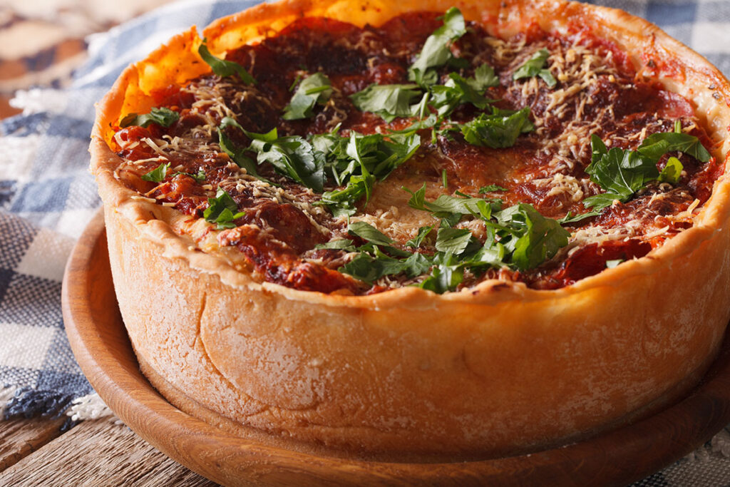 Chicago-style Deep Dish pizza with pepperoni and fresh basil