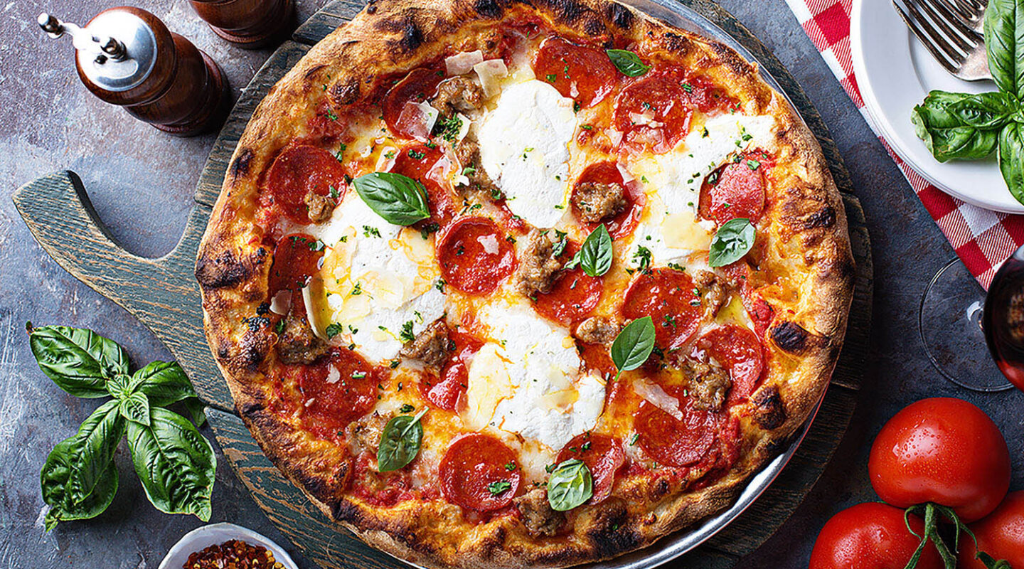 Italian style pepperoni pizza with fresh basil