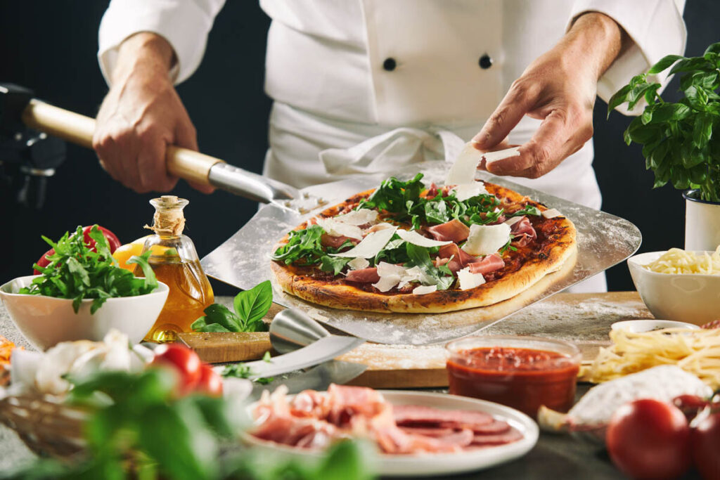 Topping a pizza with fresh ingredients