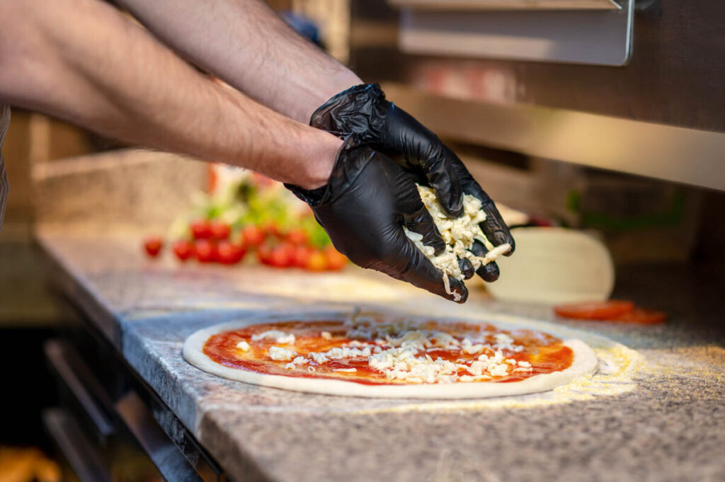 Chef prepping pizza in a pizzeria