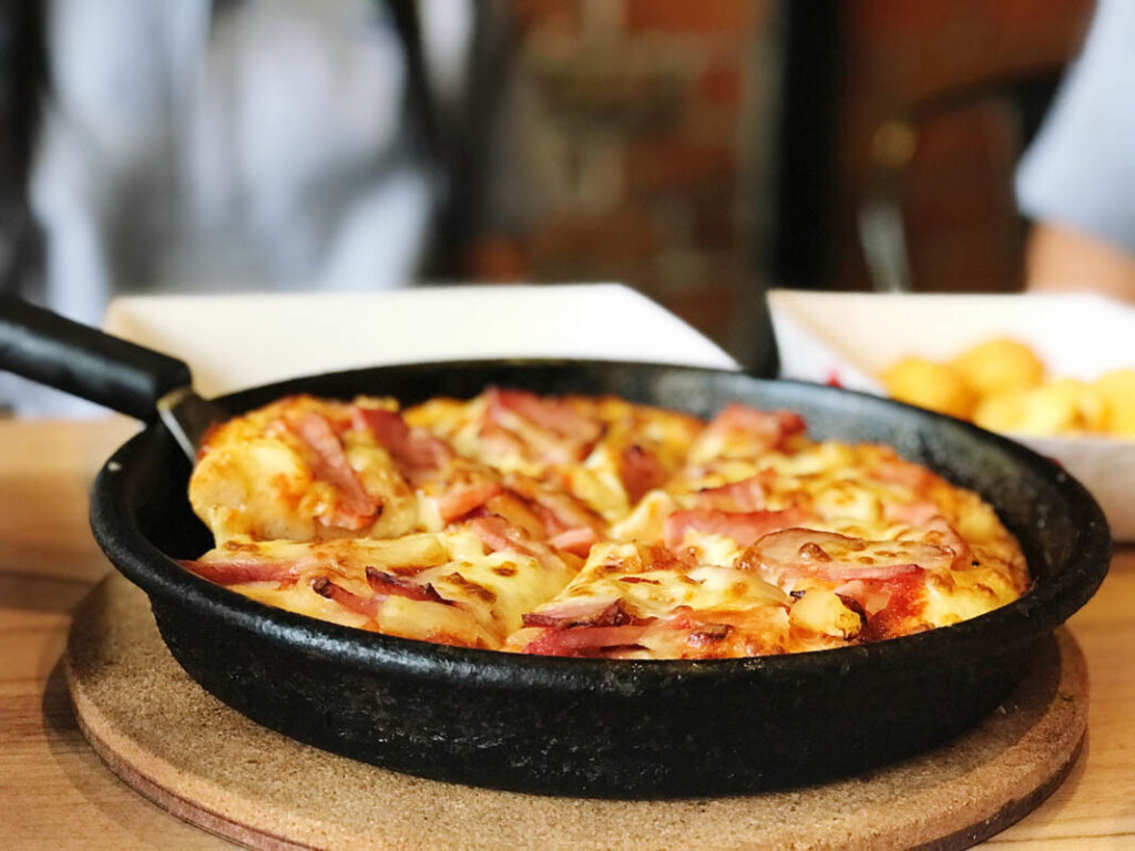 Hawaiian style pan pizza in a skillet