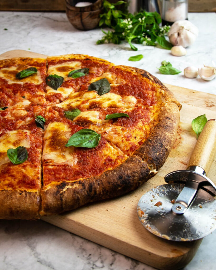 Angled view of a Margherita pizza fresh out of the oven