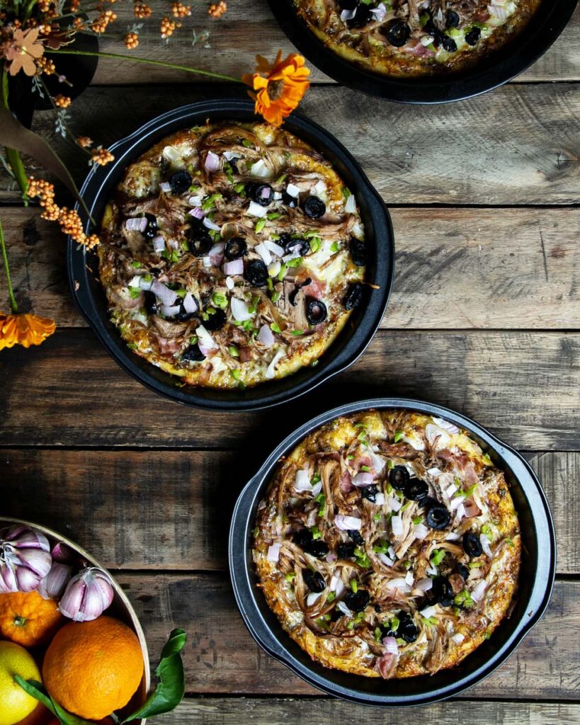 top view of multiple cuban pizza topped with shredded pork and veggies